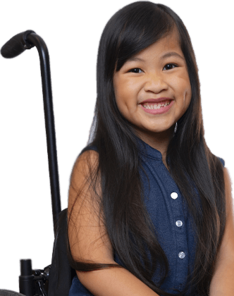 Smiling child in wheelchair after dentistry for special needs