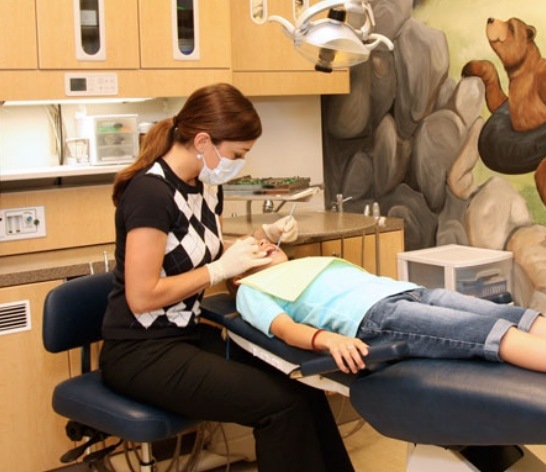 Pediatric dentist providing safe children's dentistry treatment