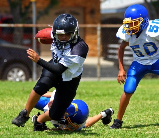 Childre with athletic mouthguard playing football