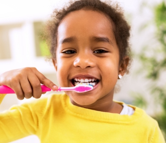 Child brushing teeth to prevent dental emergencies