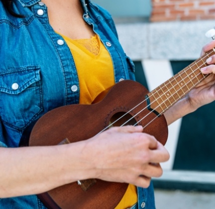 Person playing a ukulele