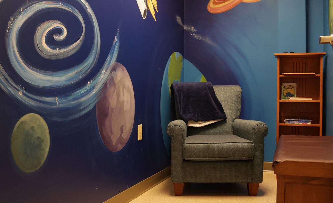 Cozy chair and book shelf in pediatric dental office