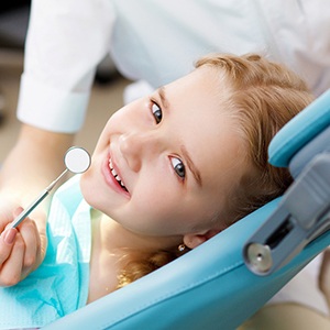 Young girl smiling in the dentist’s chair