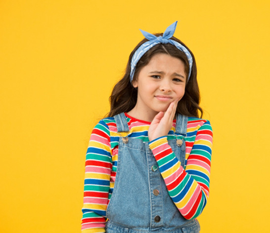Frowning young girl with a toothache