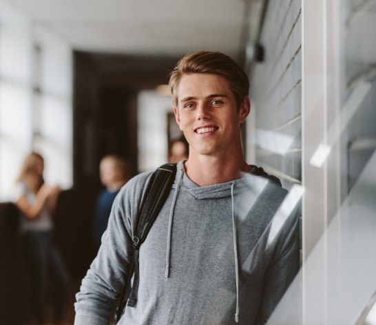 Young man smiling after dentistry for teens