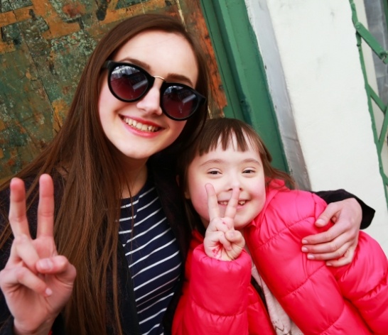 Young patient and parent smiling after special needs dentistry visit