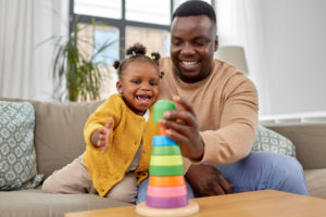 a parent playing with their child in their living room